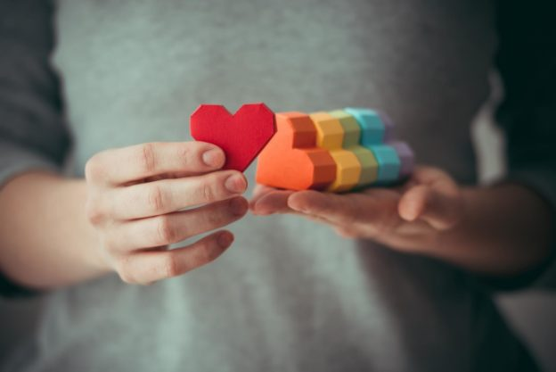 hands holding colored hearts